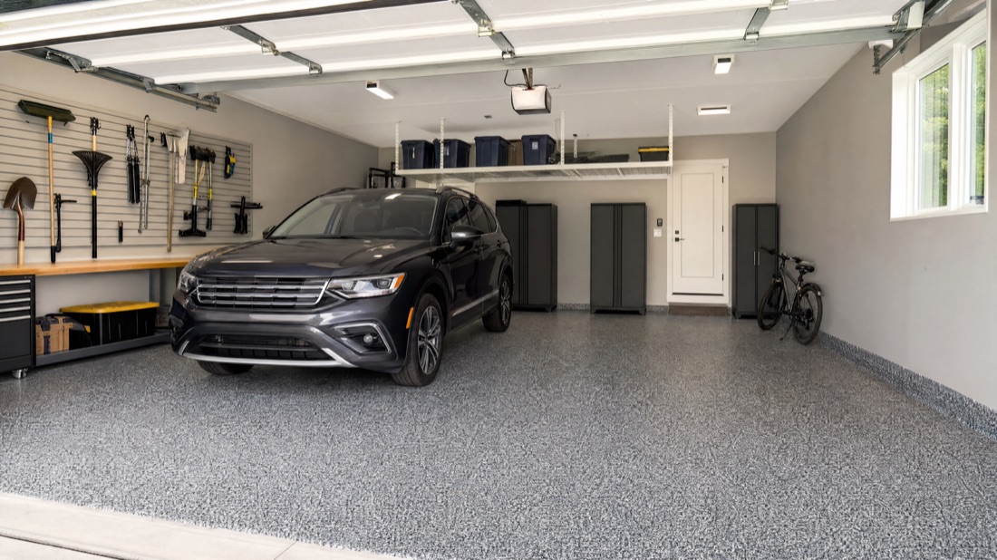 Finished garage floor with an SUV parked on the new flake coating