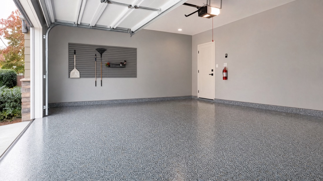 Empty two-car garage with a clean gray-flake coated floor